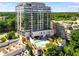 Modern high-rise building with a rooftop pool and lush green surroundings at 2233 Peachtree Ne Rd # 1207, Atlanta, GA 30309