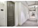 Well-lit hallway shows unit number, gray door, neutral walls, and carpeting at 2233 Peachtree Ne Rd # 1207, Atlanta, GA 30309
