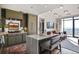 Bright kitchen featuring green cabinetry, a white island with seating, and floor to ceiling windows at 2233 Peachtree Ne Rd # 1207, Atlanta, GA 30309