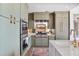 Well-equipped kitchen with stainless steel appliances and sleek, green custom cabinetry at 2233 Peachtree Ne Rd # 1207, Atlanta, GA 30309