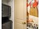 Convenient stacked washer and dryer unit is located near a doorway with bold artwork at 2233 Peachtree Ne Rd # 1207, Atlanta, GA 30309
