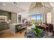 Bright open-plan living space with island seating, modern fixtures, and large windows showcasing scenic views at 2233 Peachtree Ne Rd # 1207, Atlanta, GA 30309
