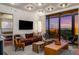Stylish living room with modern lighting, open bedroom access, and balcony with panoramic city skyline views at 2233 Peachtree Ne Rd # 1207, Atlanta, GA 30309