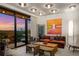 Living area with balcony and modern decor, featuring floor-to-ceiling windows with panoramic sunset views at 2233 Peachtree Ne Rd # 1207, Atlanta, GA 30309