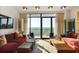 Living room with floor-to-ceiling windows offers natural light and scenic views of the outdoors at 2233 Peachtree Ne Rd # 1207, Atlanta, GA 30309