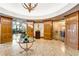 A grand lobby features a tray ceiling, gold chandelier, marble floors, and round entryways with glass doors at 2233 Peachtree Ne Rd # 1207, Atlanta, GA 30309