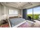 Bright main bedroom featuring a large window to balcony with seating and a stylish ceiling fan at 2233 Peachtree Ne Rd # 1207, Atlanta, GA 30309