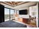 Modern main bedroom featuring a city view, dark wood dresser, and stylish chandelier at 2233 Peachtree Ne Rd # 1207, Atlanta, GA 30309