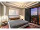 Comfortable main bedroom with modern decor, side tables, ceiling fan, and access to balcony at 2233 Peachtree Ne Rd # 1207, Atlanta, GA 30309