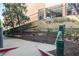 A pet waste station is located at the edge of the sidewalk in a turfed area with shade trees at 2233 Peachtree Ne Rd # 1207, Atlanta, GA 30309