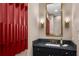 Stylish powder room with unique red accent wall, sleek vanity, and modern fixtures at 2233 Peachtree Ne Rd # 1207, Atlanta, GA 30309