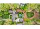 Aerial view of the property showcasing the kidney-shaped pool, detached garage and extensive wooded land around the house at 3489 Knollwood Nw Dr, Atlanta, GA 30305