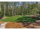 Manicured backyard with lush green lawn and surrounding trees at 3489 Knollwood Nw Dr, Atlanta, GA 30305