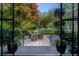 Backyard view of the pool with green lawn and lush garden with outdoor seating at 3489 Knollwood Nw Dr, Atlanta, GA 30305