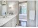 Bathroom featuring marble countertop vanity and a doorway leading to a tub with a chandelier at 3489 Knollwood Nw Dr, Atlanta, GA 30305