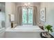 Window view from luxurious bathtub with chandelier and neutral-toned curtains at 3489 Knollwood Nw Dr, Atlanta, GA 30305