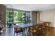 Open dining area with black table looking out to pool and lush greenery at 3489 Knollwood Nw Dr, Atlanta, GA 30305