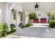 Covered driveway features red garage doors, lovely landscaping, and ample parking at 3489 Knollwood Nw Dr, Atlanta, GA 30305