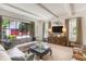 Comfortable living room featuring large windows, a gray sectional, and stylish decor at 3489 Knollwood Nw Dr, Atlanta, GA 30305