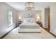 Comfortable bedroom with white carpet, neutral walls and a hanging chandelier at 3489 Knollwood Nw Dr, Atlanta, GA 30305
