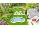 Aerial view of the backyard featuring a uniquely shaped pool, outdoor lounge area, and manicured landscaping at 3489 Knollwood Nw Dr, Atlanta, GA 30305