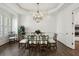 Elegant dining room with hardwood floors, chandelier, and view to the kitchen at 3707 Peachtree Ne Rd # 8, Atlanta, GA 30319