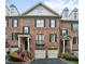 Charming brick townhome featuring black shutters, dormer windows, and well-maintained landscaping at 3707 Peachtree Ne Rd # 8, Atlanta, GA 30319