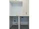 Bright laundry room featuring white cabinetry and granite countertop at 3707 Peachtree Ne Rd # 8, Atlanta, GA 30319