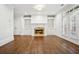 Open-concept living room features built-in shelving, a fireplace, and French doors to outdoor area at 3707 Peachtree Ne Rd # 8, Atlanta, GA 30319