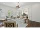 Bright living room featuring hardwood floors, white trim, and view to dining area at 3707 Peachtree Ne Rd # 8, Atlanta, GA 30319