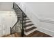 Elegant staircase with dark wood steps, white risers, and decorative black iron railing at 3707 Peachtree Ne Rd # 8, Atlanta, GA 30319