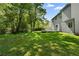 Home's backyard featuring a well-maintained lawn and trees, with a view of a small deck at 6703 Cameron Rd, Morrow, GA 30260