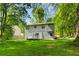 Home's backyard with a small white deck, green lawn, and view of a neighboring home at 6703 Cameron Rd, Morrow, GA 30260