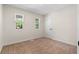Neutral bedroom with carpet, two windows, and a white door at 6703 Cameron Rd, Morrow, GA 30260