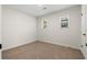 Bright bedroom with carpet, two windows, and a white door at 6703 Cameron Rd, Morrow, GA 30260