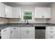 Modern kitchen featuring stainless steel appliances, granite countertops, and white cabinets at 6703 Cameron Rd, Morrow, GA 30260