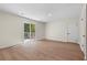Bright living room featuring wood-look flooring and sliding glass doors to the deck at 6703 Cameron Rd, Morrow, GA 30260