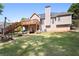 A multi-tiered deck overlooks the spacious backyard with a firepit at 840 Whitby Dr, Douglasville, GA 30134