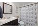 Bathroom with dark wood vanity, framed mirror, and shower with decorative leaf curtain at 840 Whitby Dr, Douglasville, GA 30134