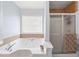 A close up of the bathroom with a garden tub and separate shower with sliding glass doors at 840 Whitby Dr, Douglasville, GA 30134