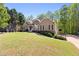 Landscaped front yard leads up to a cozy home exterior with stone accents and inviting curb appeal at 840 Whitby Dr, Douglasville, GA 30134