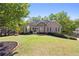 Charming home boasts a well-manicured lawn, complemented by mature trees and a stone facade entrance at 840 Whitby Dr, Douglasville, GA 30134