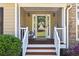 Inviting covered front porch featuring stone accents and a decorative glass door at 840 Whitby Dr, Douglasville, GA 30134