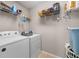 Functional laundry room with washer, dryer, and shelving for storage at 840 Whitby Dr, Douglasville, GA 30134