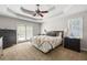 Tranquil main bedroom with private access to a patio, neutral decor, and tray ceilings at 840 Whitby Dr, Douglasville, GA 30134