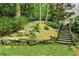 Multi-tiered backyard featuring stone steps, landscaping, and a retaining wall at 2562 Red Valley Rd, Atlanta, GA 30305