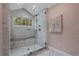 Luxurious walk-in shower featuring marble tile, a rainfall showerhead, and built in bench at 2562 Red Valley Rd, Atlanta, GA 30305