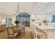 Expansive kitchen with an island, bar seating, a dining table, and an outdoor view at 2562 Red Valley Rd, Atlanta, GA 30305