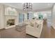 Cozy living room with fireplace, white sofas, and access to the kitchen and outdoor dining area at 2562 Red Valley Rd, Atlanta, GA 30305