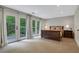 Spacious main bedroom featuring plush carpeting and French doors leading to a private patio at 2562 Red Valley Rd, Atlanta, GA 30305